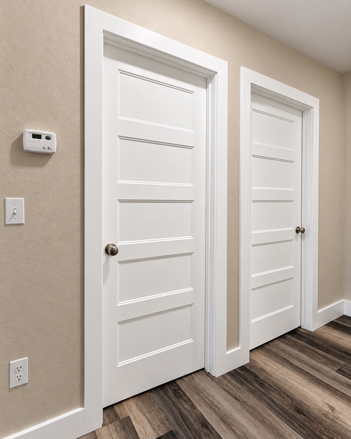 White paneled interior doors with crisp casing, baseboards, and wood-look flooring